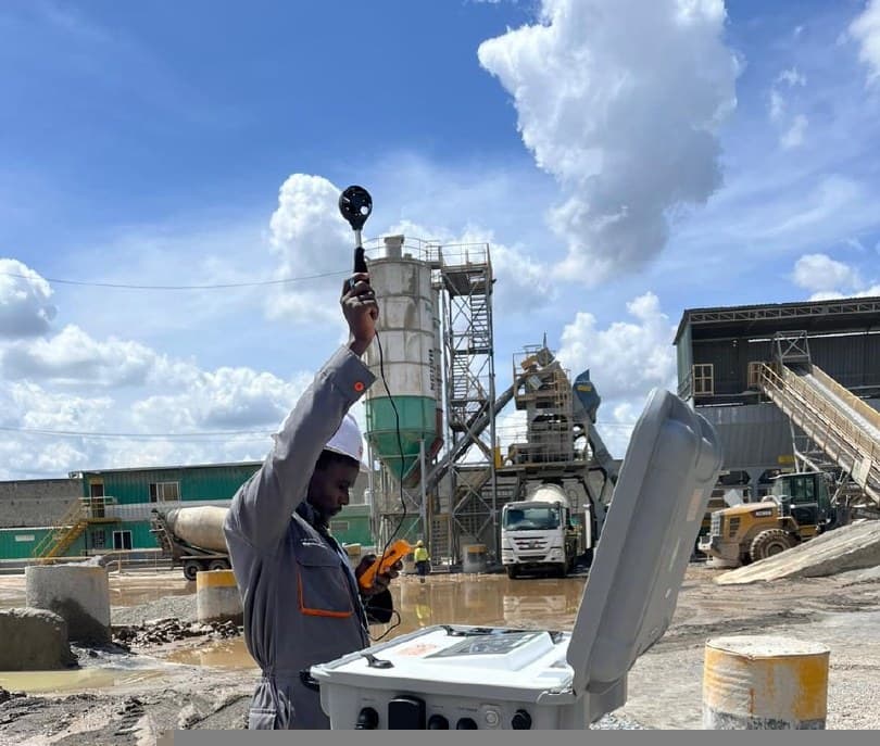 A SEEL technician taking ambient air measurements at a concrete batching plant