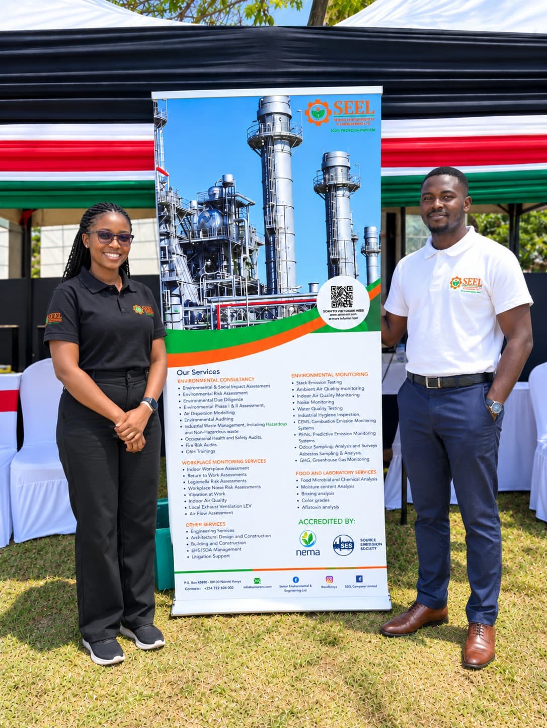 Four SEEL staff in branded shirts between two of the company's pull-up banners at an outdoor event